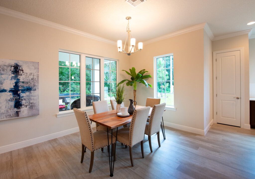 fully furnished dining area with chairs and table in villa at Village on the Green Senior Living Community